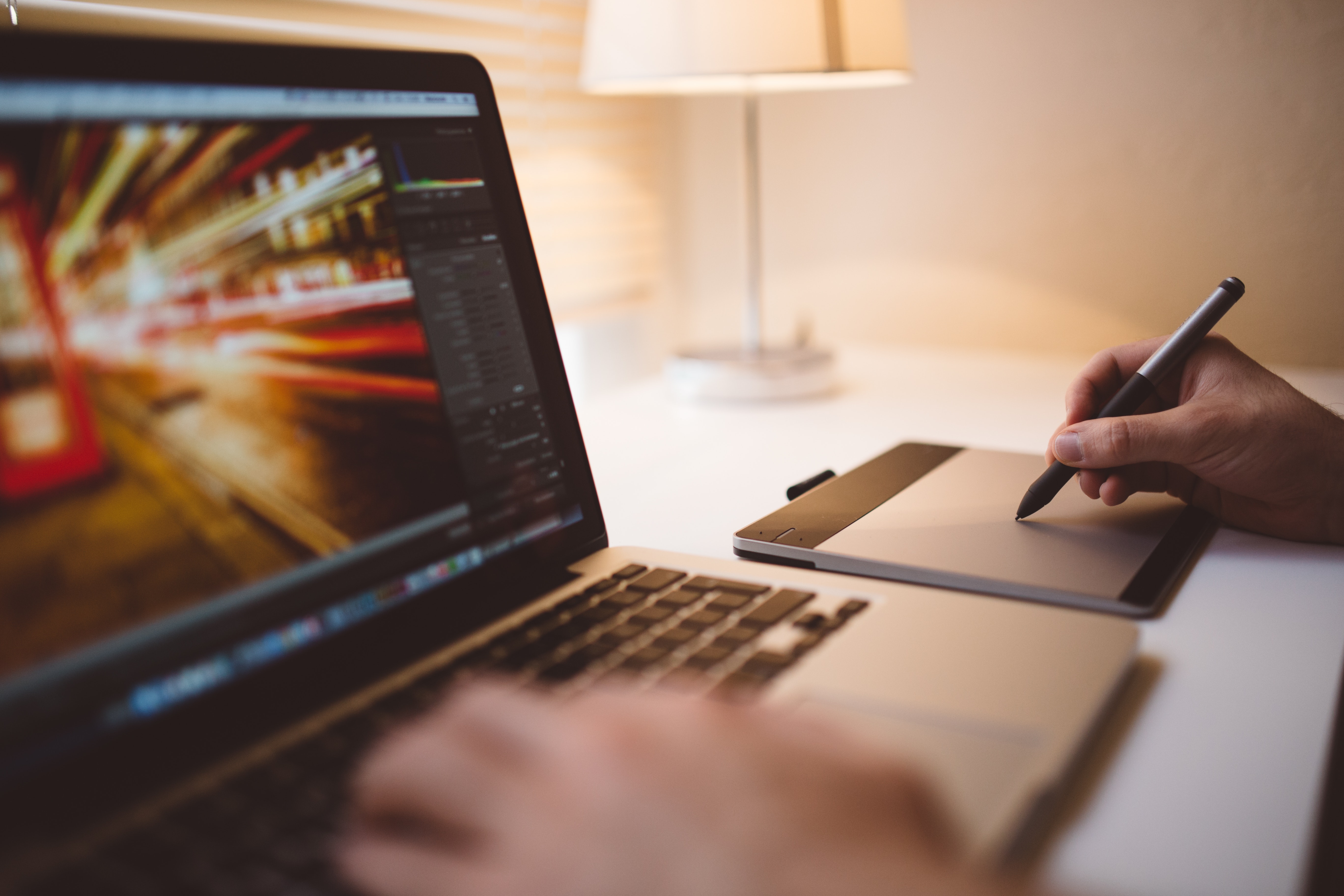 Video Editing - A laptop, with a person editing video